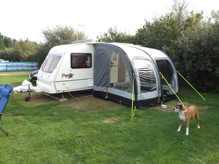 Caravana con avance hinchable en una parcela de camping
